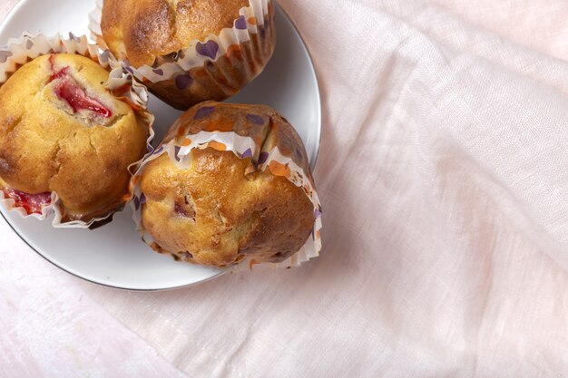 Homemade muffins with red berries and cherries