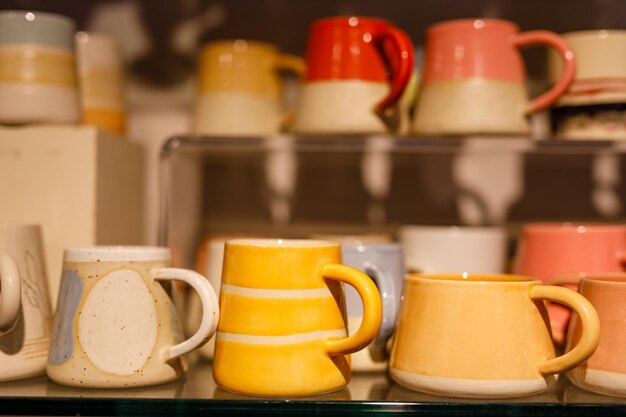 homemade mugs are on display in a store