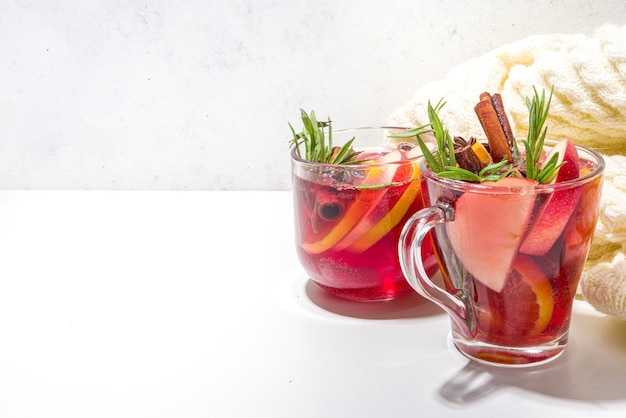 Homemade mulled wine cocktail. Various glass mugs with classic winter hot spicy mulled wine, with ingredients on white background flatlay top view copy space