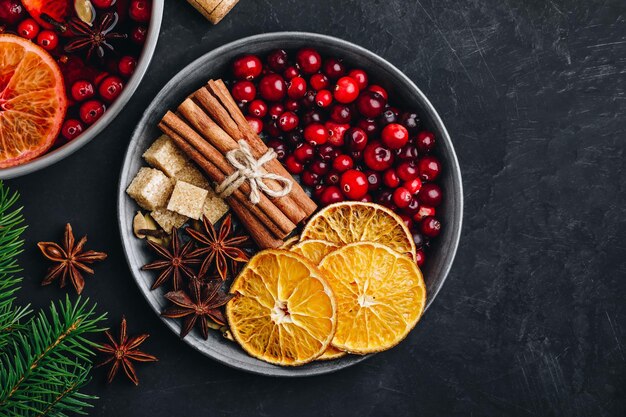 Homemade Mulled Wine recipe Mulled Wine Ingredients with cranberries oranges cinnamon anise and cardamom top view