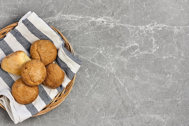 homemade multi cereal buns on gray stone background