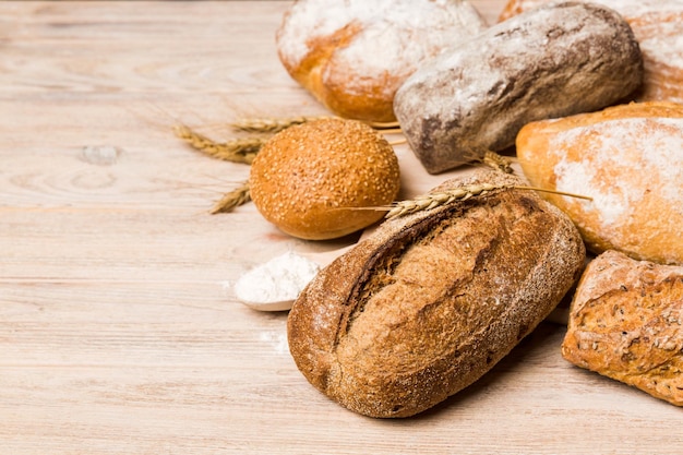 Homemade natural breads Different kinds of fresh bread as background perspective view with copy space