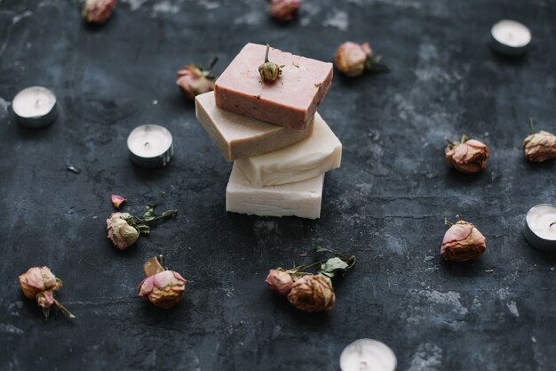 Homemade natural organic floral soap and flowers on dark 