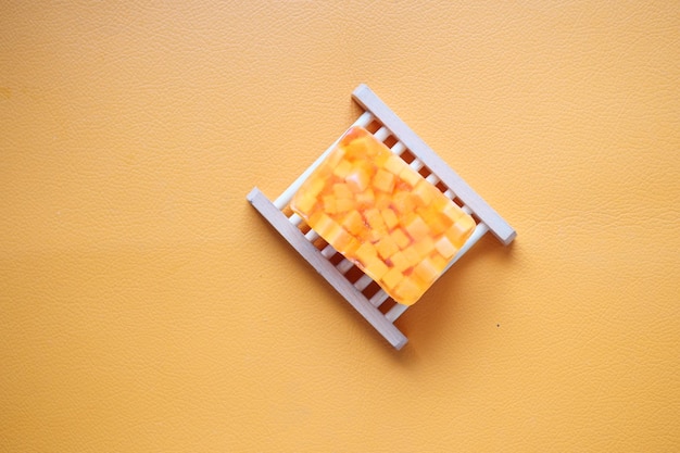 Homemade natural soap bar on orange background