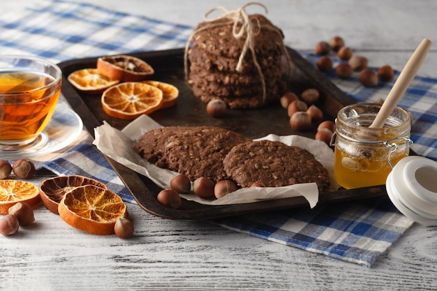 Homemade oat cookies baked on vintage tray with nuts