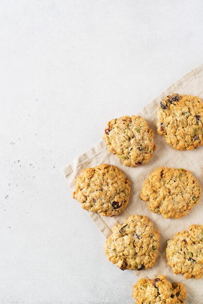 Homemade oat cookies on white background, healthy snack, copy space