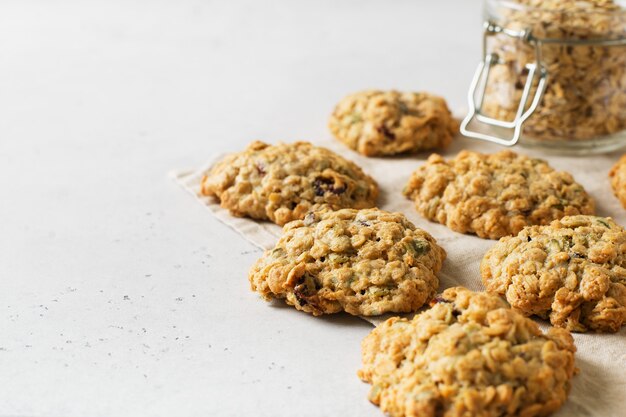 Homemade oat cookies on white background, healthy snack, copy space