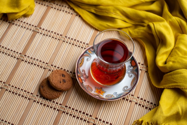 Homemade oatmeal cookies with a cup of tea with yellow scarf