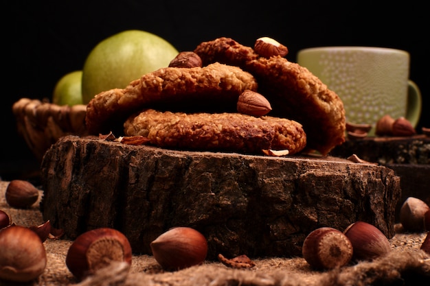 Homemade oatmeal cookies with hazelnuts on wooden background