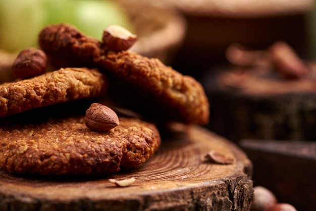 Homemade oatmeal cookies with hazelnuts on wooden surface