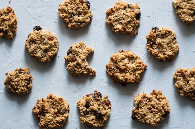 homemade oatmeal cookies with raisins and nuts on a gray background