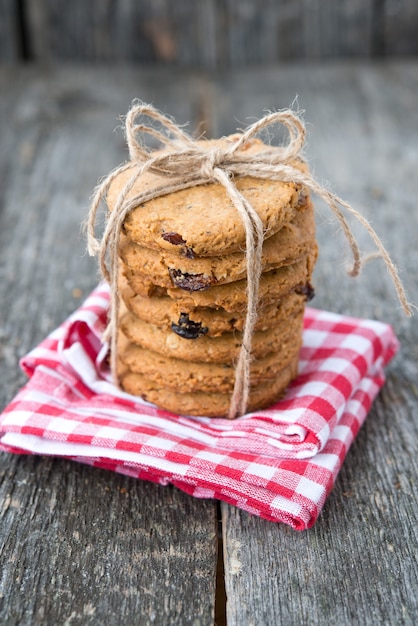 Homemade oatmeal cookies with raisins on a rustic wooden table