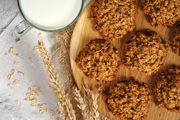 Homemade oatmeal cookies on wooden board on old table background Healthy Food Snack Concept Copy space High quality photo