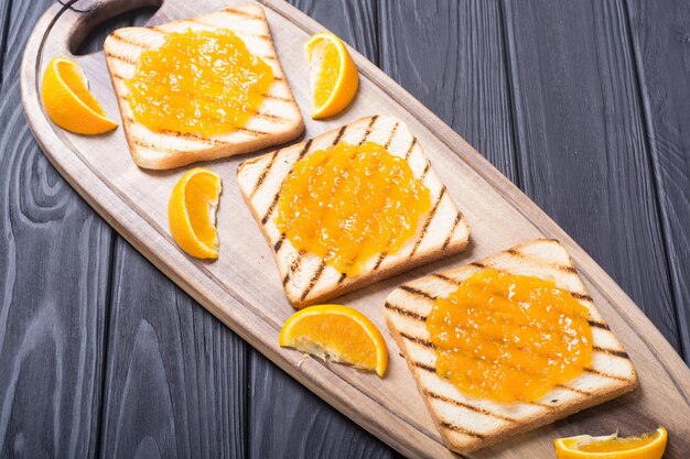 Homemade orange jam toast on wooden table fruit breakfast