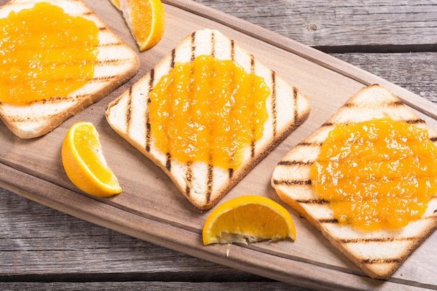 Homemade orange jam toast on wooden table fruit breakfast