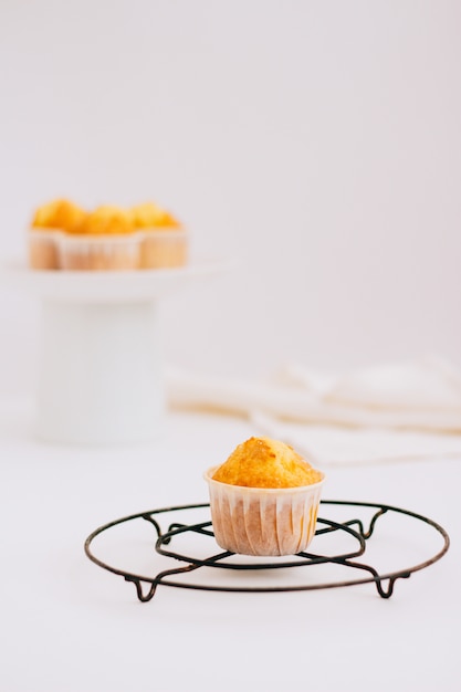 Homemade orange muffins on a metal stand 