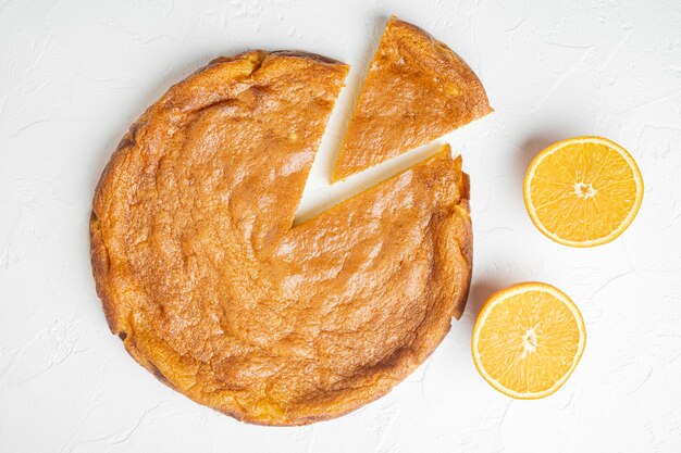 Homemade orange polenta and almond  cake set, on white stone table background, top view flat lay