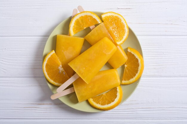 Homemade orange popsicle summer frozen juice background