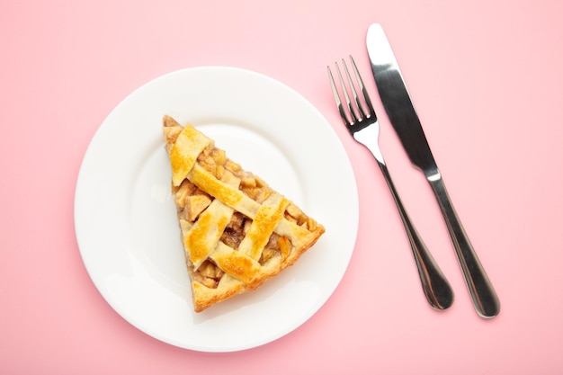 Homemade organic apple pie dessert ready to eat on pink background Top view