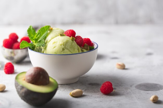 Homemade organic avocado and mint ice cream in a bowl with copy space