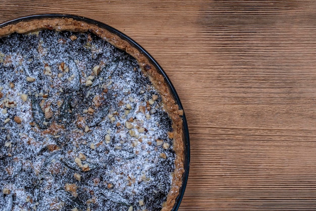 Homemade organic blueberry pie dessert ready to eat close up Blueberry tart with walnut Close up copy space