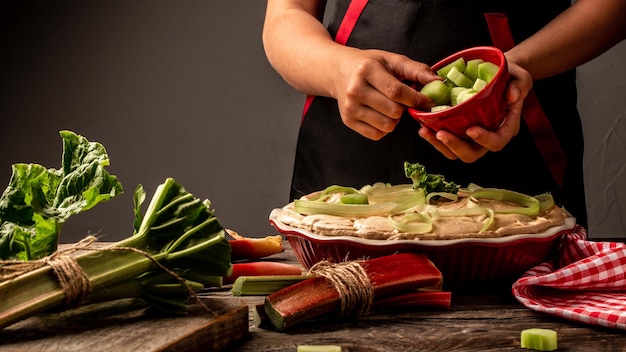 Homemade organic traditional rhubarb pie on wooden rustic table Fresh baked rhubarb pie in the hands of the hostess space for text banner menu recipe