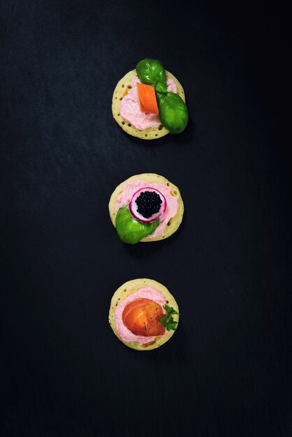 Homemade pancake canapes on slate stone plate for finger food party