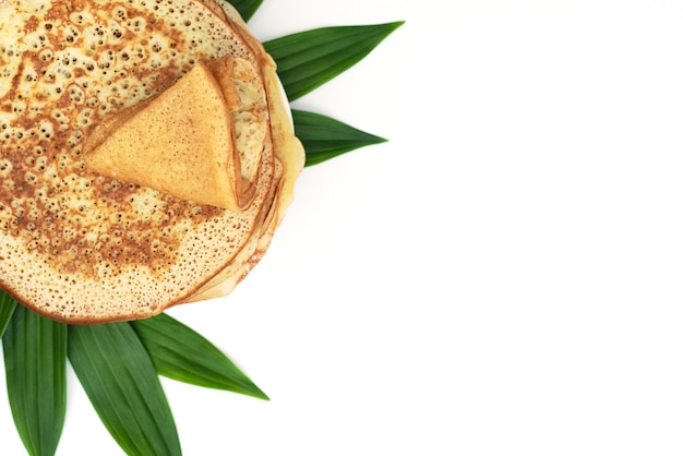 Homemade pancakes isolated with green leaves