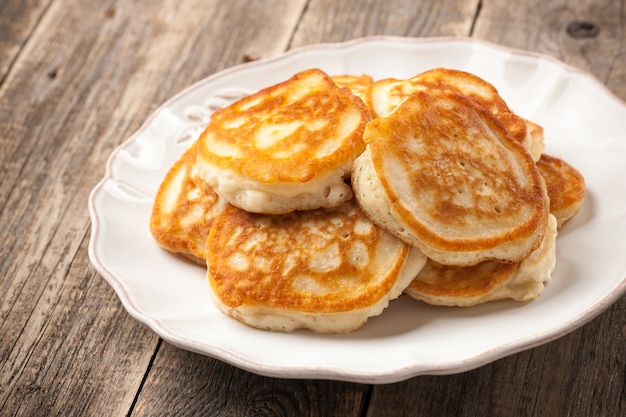 Homemade pancakes in a plate on wooden table