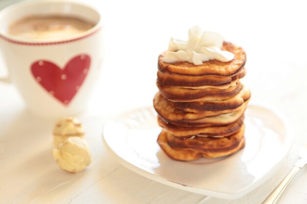 Homemade pancakes with breackfast coffee cup healthy morning breakfast with candies on white