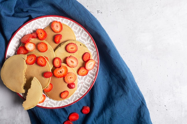 Homemade Pancakes with strawberries and Butter. Ready for breakfast. Top view