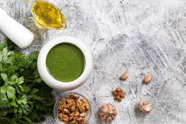 Homemade parsley pesto sauce and ingredients.