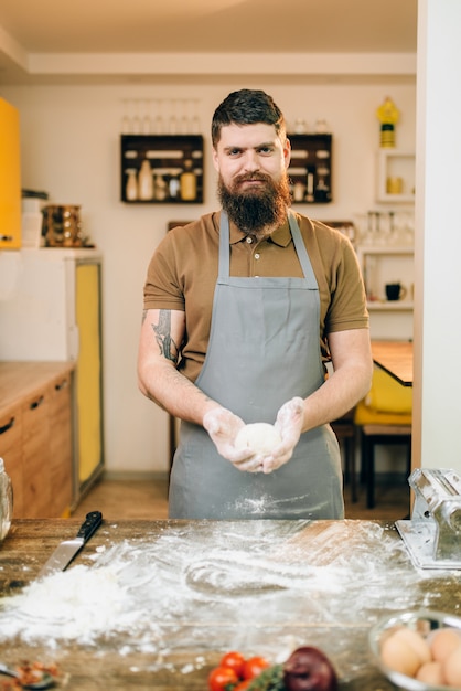 Homemade pasta cooking, male hands with dough