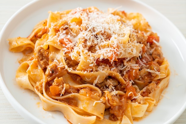 Homemade pasta fettuccine bolognese with cheese - Italian food style