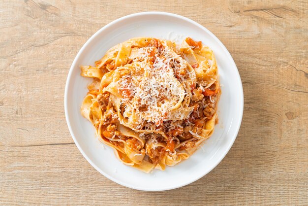 Homemade pasta fettuccine bolognese with cheese Italian food style