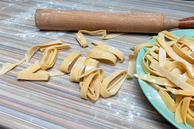 Homemade pasta preparation process with rolling pin