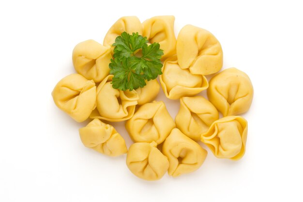 Homemade pasta,  raw tortellini with herbs.