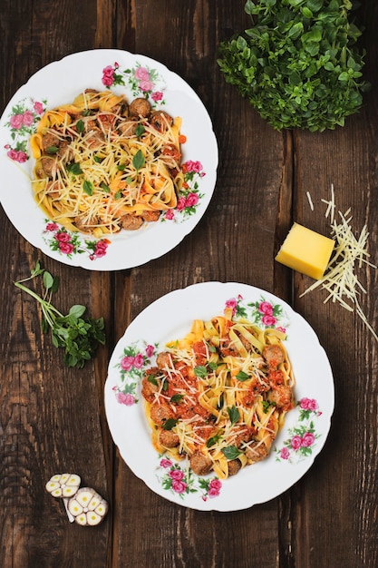 Homemade pasta tagliatelle with meatballs in tomato sauce