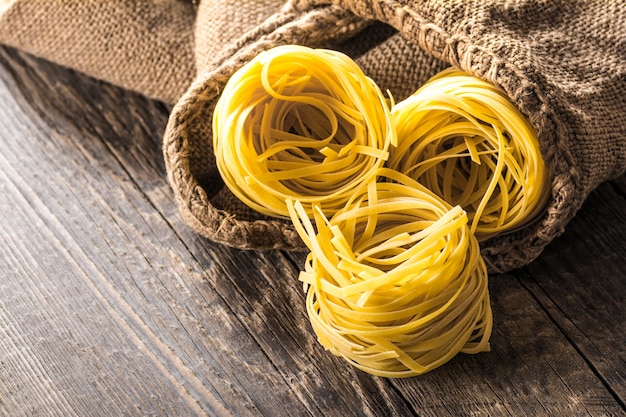 Homemade pasta on a wooden background