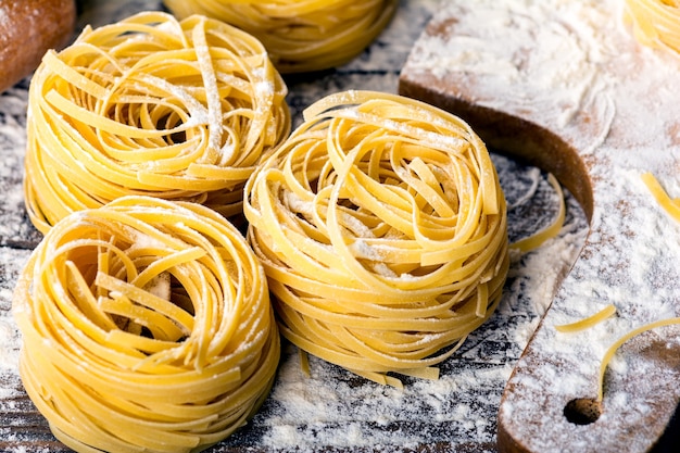 Homemade pasta on a wooden background