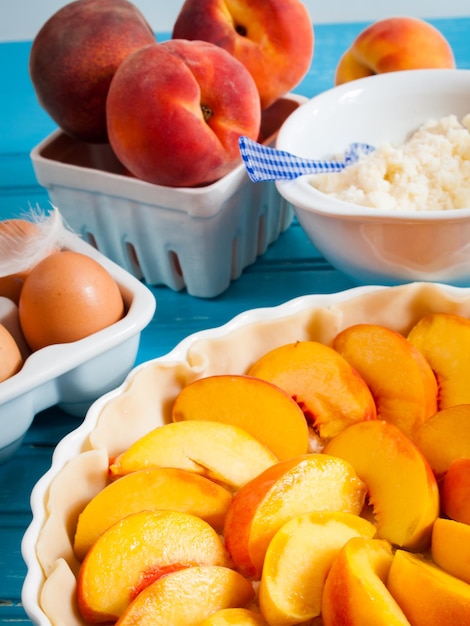 Homemade peach pie in white dish.