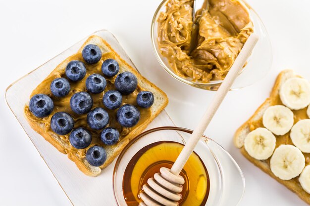 Homemade peanut butter and blueberry sandwich on white bread.