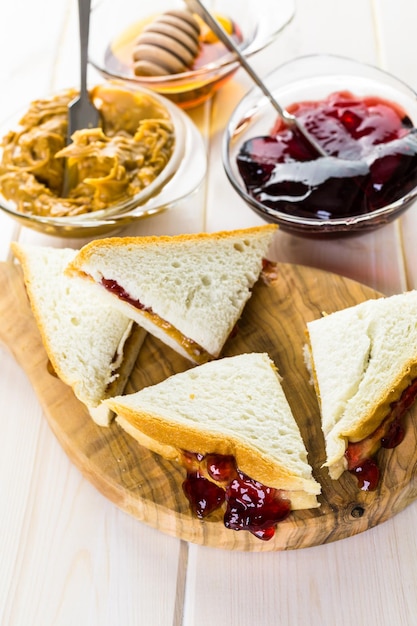 Homemade peanut butter and jelly sandwich on white bread.