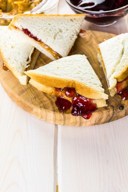 Homemade peanut butter and jelly sandwich on white bread.