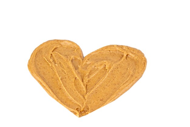 Homemade peanut butter and patterned sandwich isolated on white background The concept of love for nuts Favorite breakfast Nuts in the shape of a heart