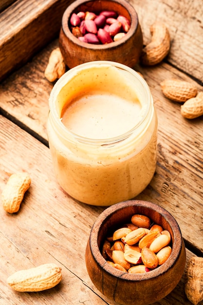 Homemade peanut butter on retro wooden table