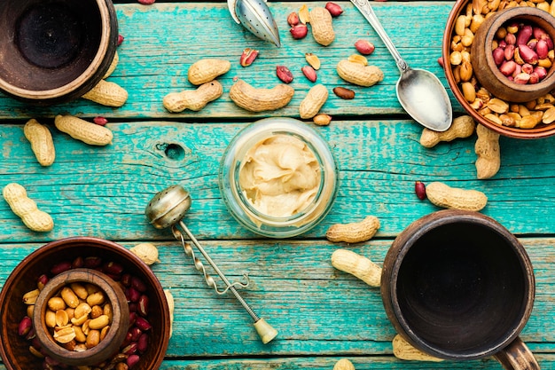 Homemade peanut butter on retro wooden table