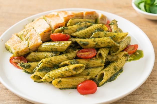 homemade penne pasta in pesto sauce with grilled chicken