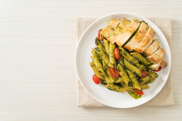 homemade penne pasta in pesto sauce with grilled chicken