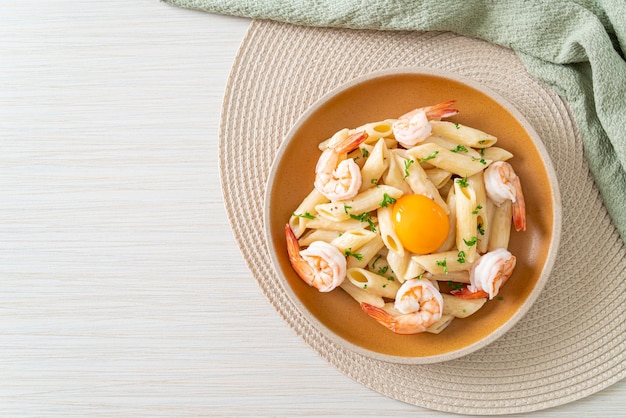 homemade penne pasta white cream sauce with shrimps and egg